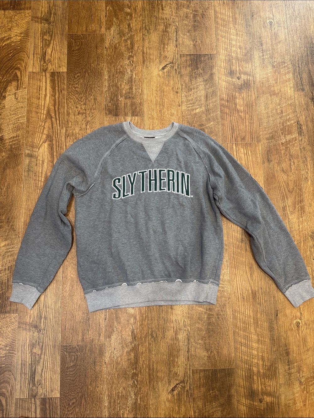 Warner Bros. Gray Slytherin Crewneck Sweatshirt with Green Lettering